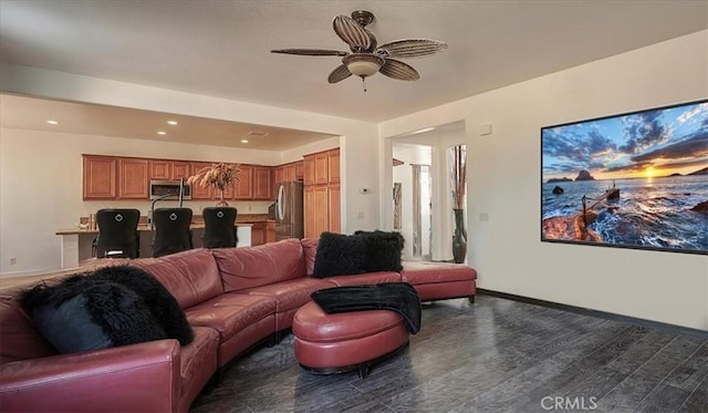 living room with dark hardwood / wood-style flooring and ceiling fan