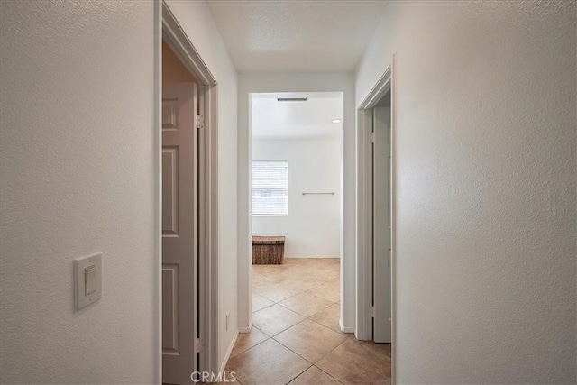 corridor featuring light tile patterned flooring