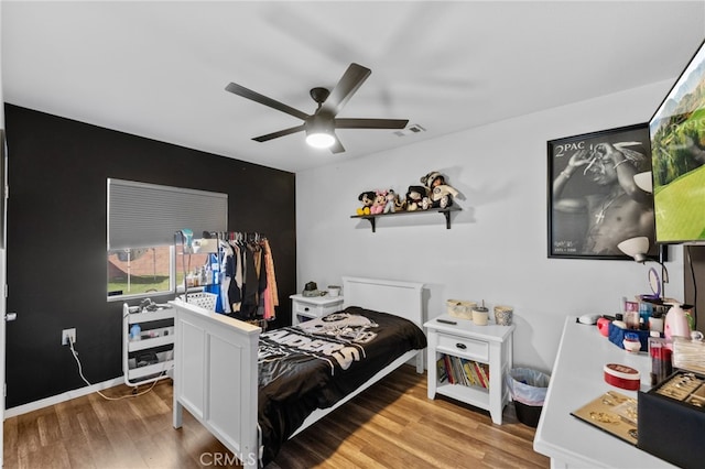 bedroom with light hardwood / wood-style flooring and ceiling fan