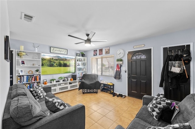 tiled living room with ceiling fan