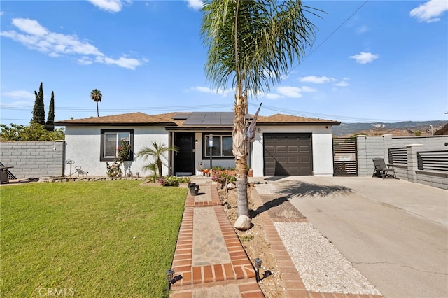 ranch-style home featuring a garage, a front lawn, and solar panels