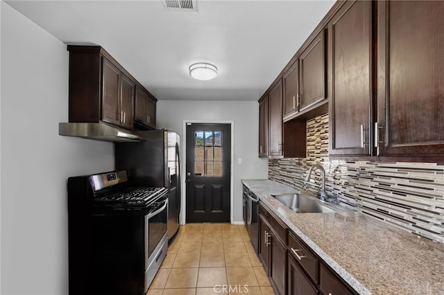 kitchen with light tile patterned floors, sink, dark brown cabinets, backsplash, and appliances with stainless steel finishes