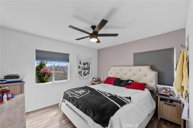 bedroom with hardwood / wood-style floors and ceiling fan