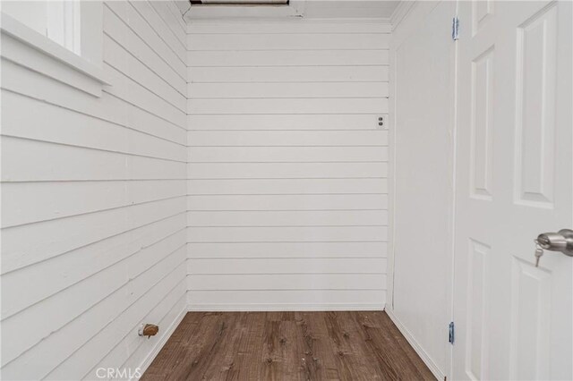 interior details featuring wooden walls and wood finished floors