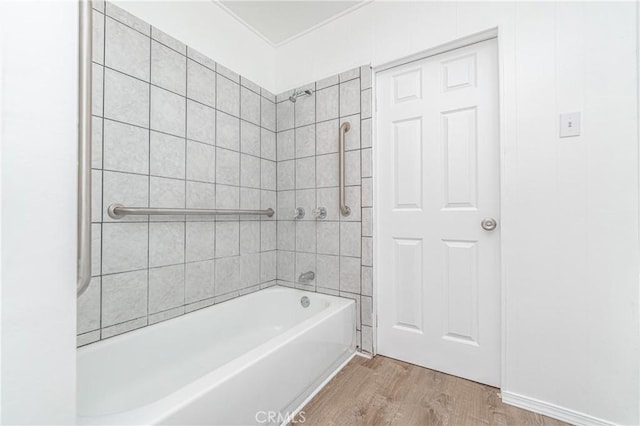 full bath featuring washtub / shower combination and wood finished floors
