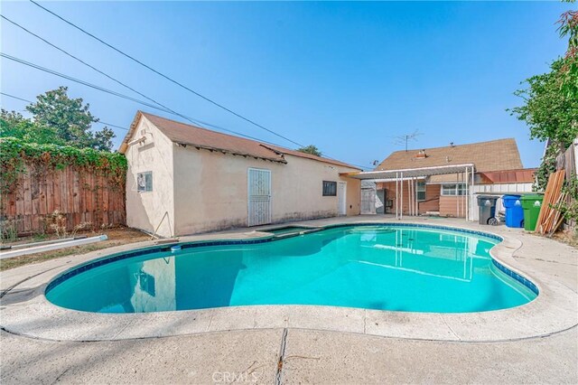 view of pool featuring a fenced in pool, an outdoor structure, a fenced backyard, and a patio area