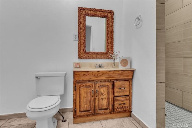 bathroom with tile patterned floors, vanity, toilet, and baseboards