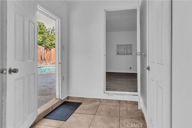 entryway featuring light tile patterned flooring and baseboards