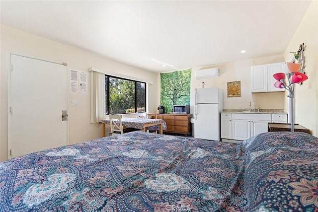 bedroom with white fridge, sink, and a wall unit AC