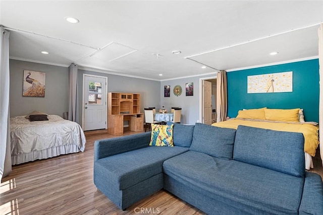 bedroom with hardwood / wood-style floors and ornamental molding