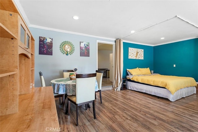 bedroom with crown molding and hardwood / wood-style floors