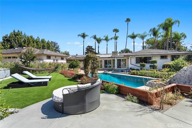 view of pool featuring a yard