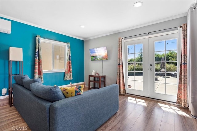 living room with a wall mounted air conditioner, french doors, hardwood / wood-style flooring, and ornamental molding