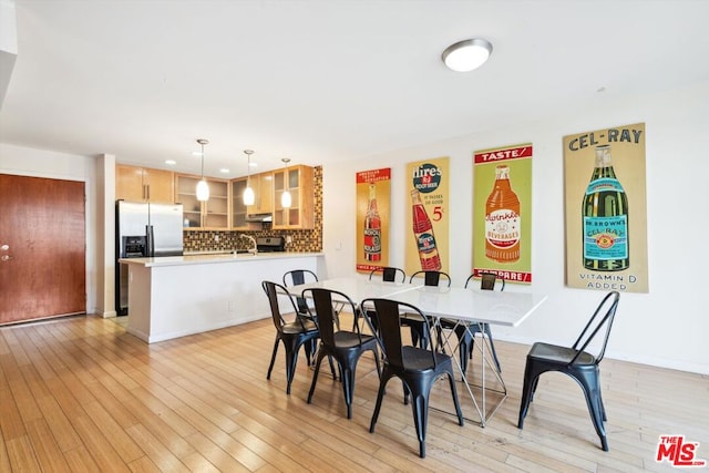 dining room featuring light hardwood / wood-style floors and sink