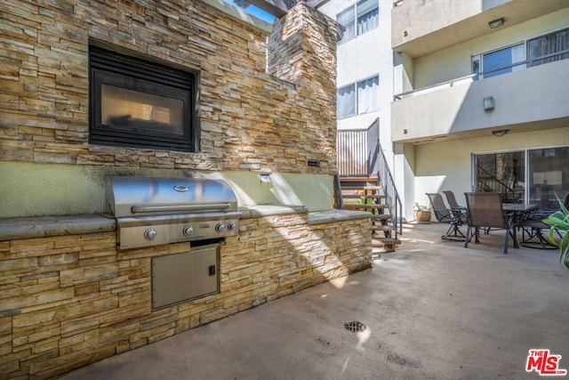 view of patio featuring area for grilling and a grill