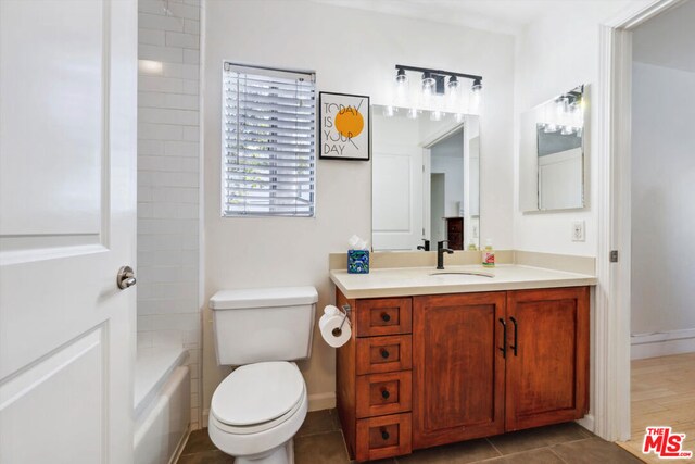 bathroom featuring tile patterned flooring, vanity, and toilet