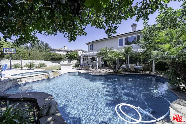 view of pool with an in ground hot tub and a patio