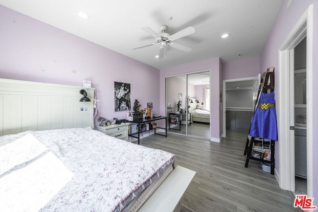 bedroom with dark hardwood / wood-style flooring, a closet, and ceiling fan