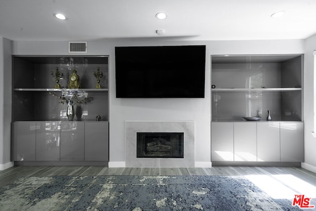 unfurnished living room with wood-type flooring