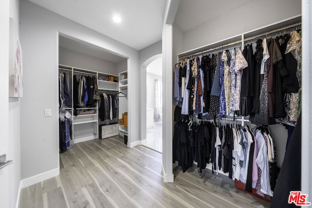 spacious closet featuring light hardwood / wood-style floors