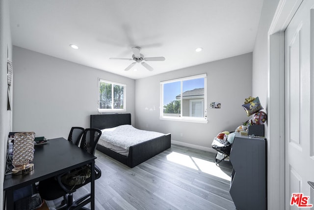 bedroom featuring hardwood / wood-style floors and ceiling fan