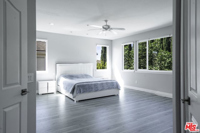 bedroom featuring ceiling fan and dark hardwood / wood-style flooring