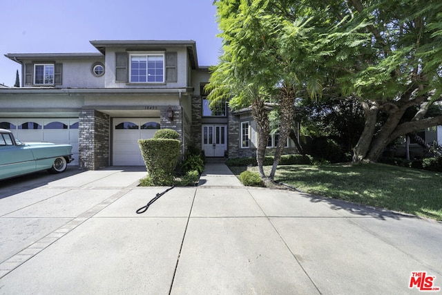 view of front of house featuring a garage and a front lawn