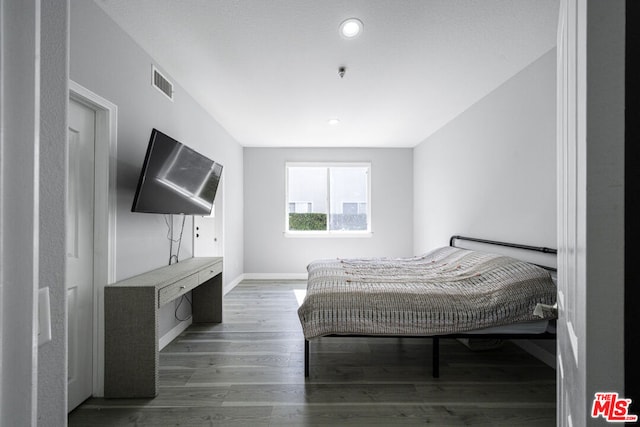 bedroom with wood-type flooring