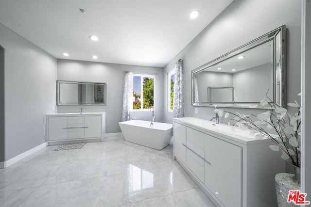 bathroom featuring vanity and a bath