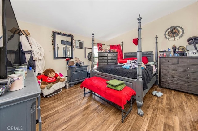 bedroom featuring hardwood / wood-style flooring and vaulted ceiling