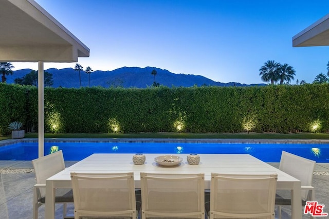 view of swimming pool featuring a mountain view and a patio area