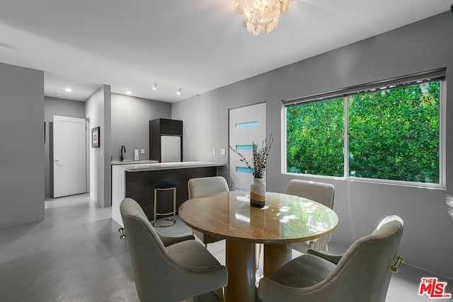 dining area with a notable chandelier and sink