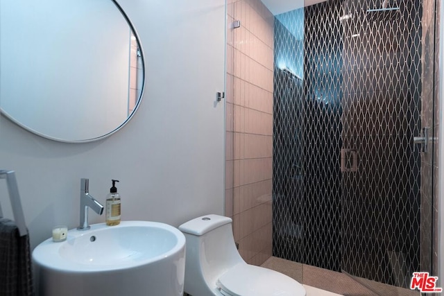 bathroom featuring an enclosed shower, toilet, and sink