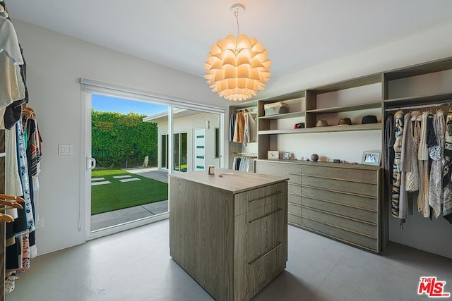 spacious closet with a notable chandelier