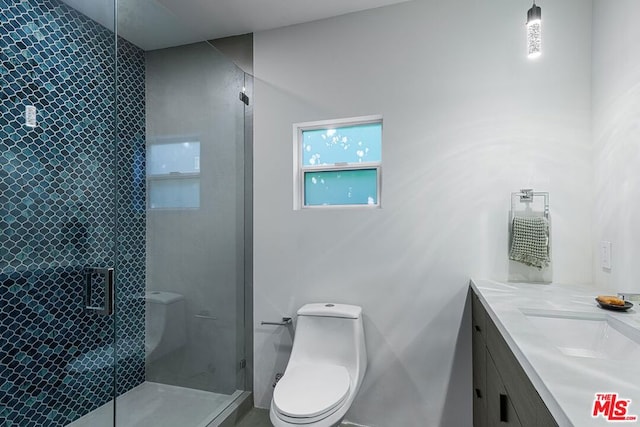 bathroom with vanity, toilet, and a shower with shower door