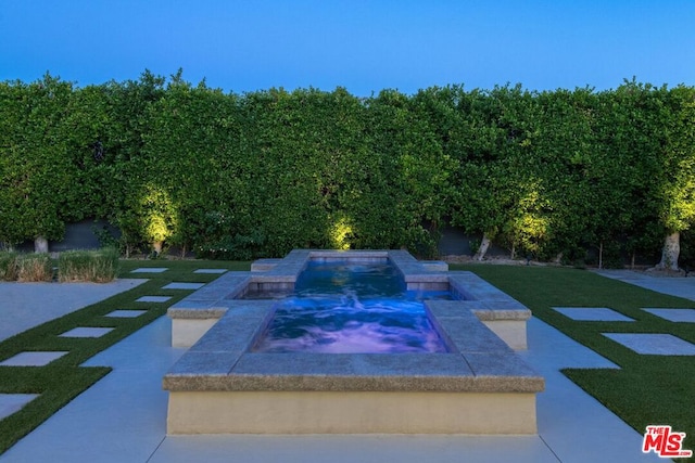 view of swimming pool featuring an in ground hot tub and a yard