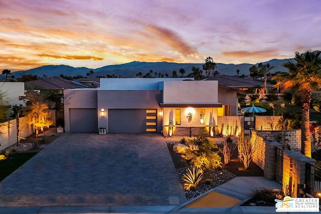 contemporary house with a mountain view and a garage