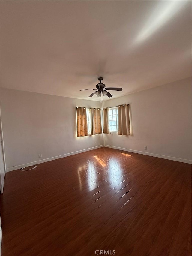 empty room featuring dark hardwood / wood-style floors and ceiling fan