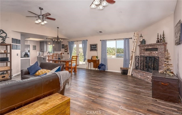 living room with ceiling fan, a fireplace, vaulted ceiling, and wood finished floors