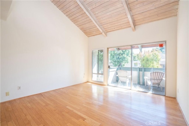 empty room featuring beamed ceiling, light wood-type flooring, wood ceiling, and high vaulted ceiling