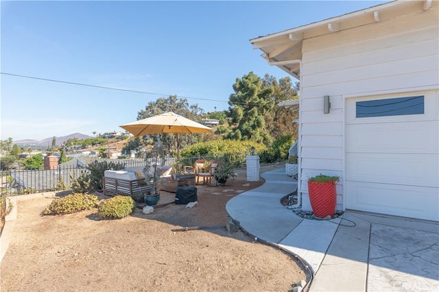 view of yard featuring a mountain view and a patio area