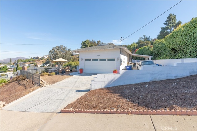 view of front of home with a garage and a mountain view