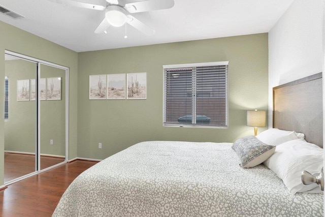 bedroom featuring dark hardwood / wood-style floors, ceiling fan, and a closet