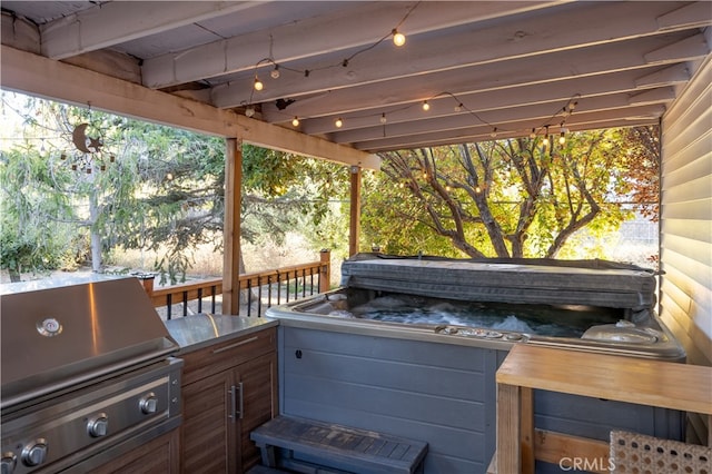 view of patio / terrace featuring a hot tub and grilling area