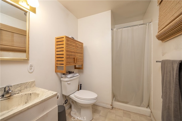 bathroom featuring vanity, toilet, and curtained shower