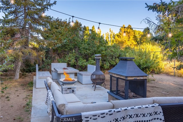 view of patio / terrace featuring an outdoor living space with a fire pit