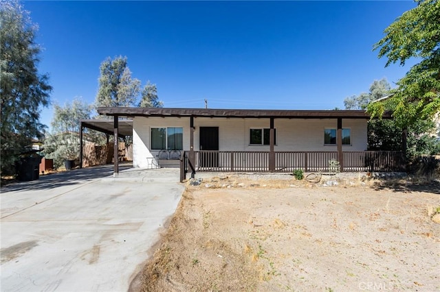 back of property with a carport