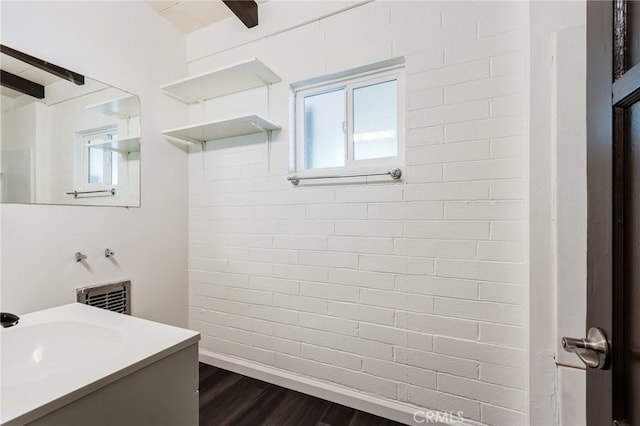 bathroom with hardwood / wood-style floors and vanity