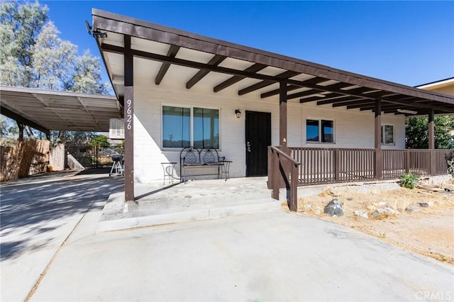 rear view of property featuring a carport