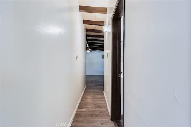 hall with hardwood / wood-style flooring and beamed ceiling